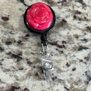 Red flower and diamond badge reel.